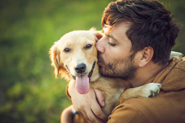 istock Guy and his dog, golden retriever, nature 1345552131