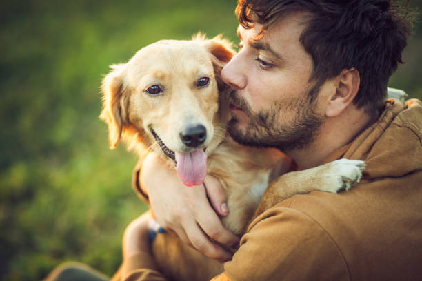 istock Guy and his dog, golden retriever, nature 1345552261