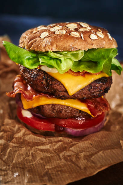 istock Double Beef Burger with Tomato, Cheese, Bacon, Onions and Lettuce 1345554634