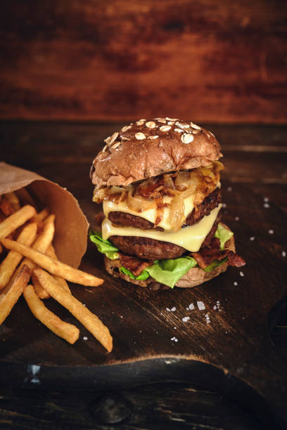 istock Double Beef Burger with Tomato, Cheese, Bacon, Onions and Lettuce 1345554639