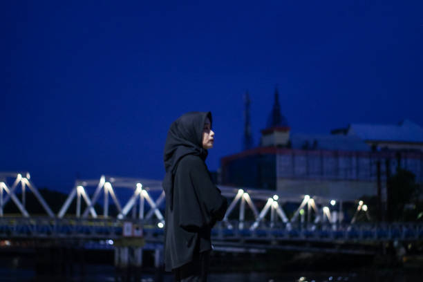istock Young Asian Hijab standing enjoyment at night 1345554797