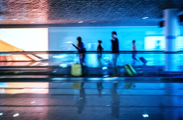 istock Motion-blurred abstract people walking to the airport terminal 1345554845