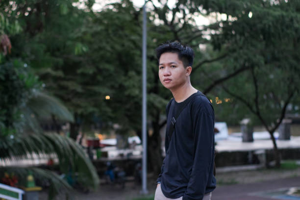 istock Young men walking at city park 1345555953