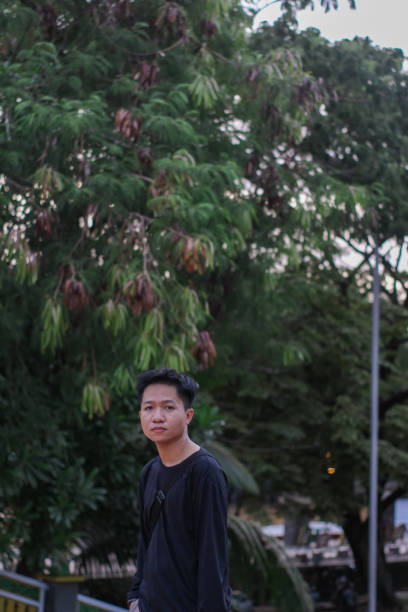 istock Young men walking at city park 1345555955