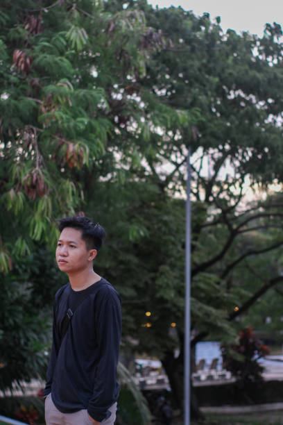 istock Young men walking at city park 1345555964