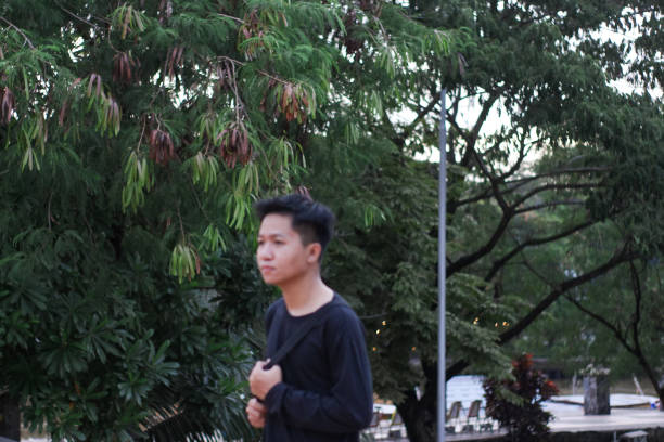 istock Young men walking at city park 1345556499