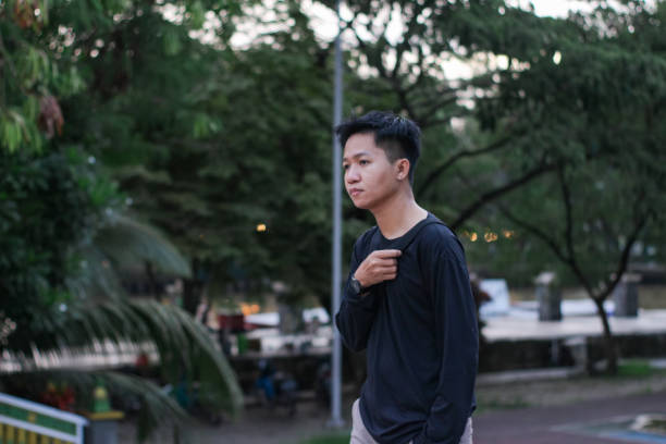 istock Young men walking at city park 1345556504