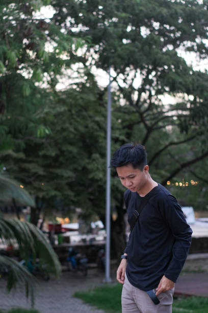 istock Young men walking at city park 1345556571