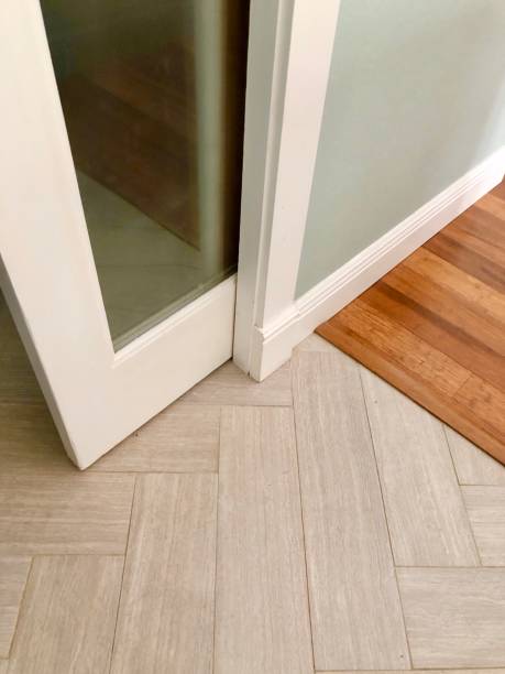Closeup pocket door Low angle closeup of white pocket door and frame with parquet tile floor pocket stock pictures, royalty-free photos & images
