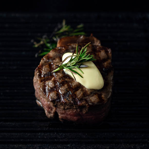 istock Grilled beef Tenderloin steak in a pan with butter on a dark background 1345558485