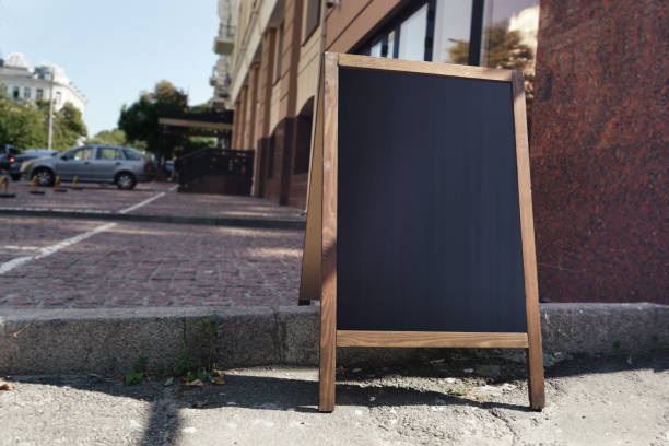 istock Street restaurant menu with empty black space in wooden frame 1345558588