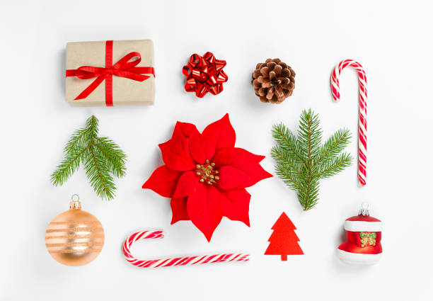 istock Kritsmas composition poinsettia, lollipop, spruce branch, gift box, red bow, boot, pine cone on a light background. 1345559867