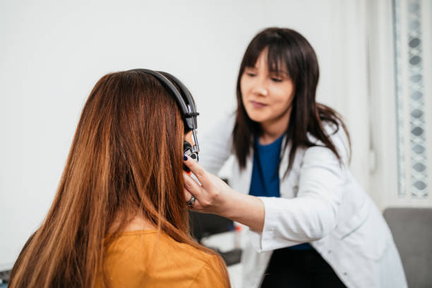 Medical hearing examination Beautiful middle age brunette woman receiving medical treatment. Hearing aid checkup. Otolaryngology. audiologist stock pictures, royalty-free photos & images