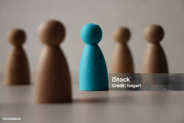 Wooden Figures On A Table Stock Photo - Download Image Now - Individuality, Standing Out From The Crowd, Privacy