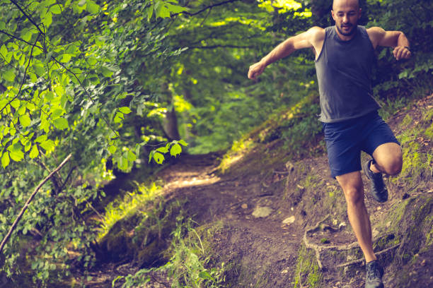 istock Trail runner with smart watch in green forest 1345561985