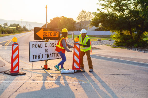 istock Hispanic Workers Setting Barriers and Directing Traffic Street Road and Highway Construction Photo Series 1345563929