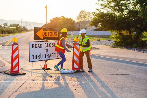 Western USA Highway, Road and Street Construction Hispanic Workers Setting Barriers and Directing Traffic with Matching 4K Video Available (Shot with Canon 5DS 50.6mp photos professionally retouched - Lightroom / Photoshop - original size 5792 x 8688 downsampled as needed for clarity and select focus used for dramatic effect)