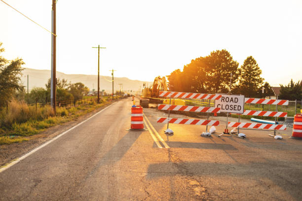 istock Hispanic Workers Setting Barriers and Directing Traffic Street Road and Highway Construction Photo Series 1345564025