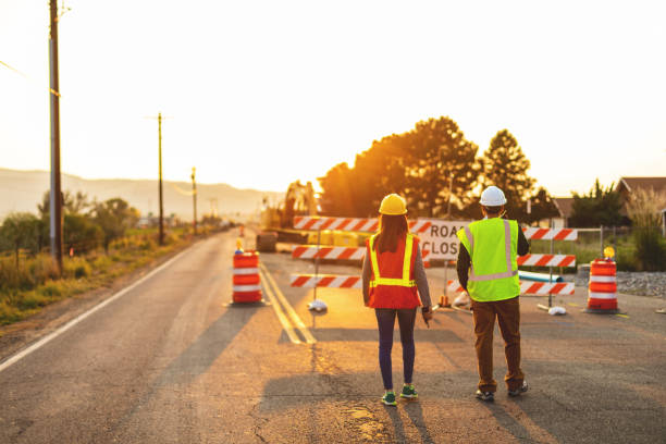 istock Hispanic Workers Setting Barriers and Directing Traffic Street Road and Highway Construction Photo Series 1345564027
