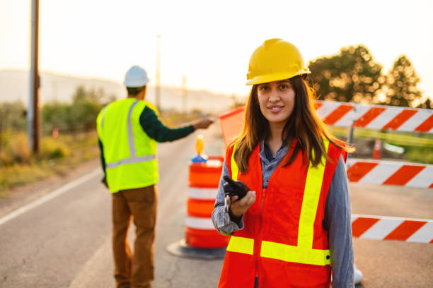 istock Communication in the Field Hispanic Workers Setting Barriers and Directing Traffic Street Road and Highway Construction Photo Series 1345564616