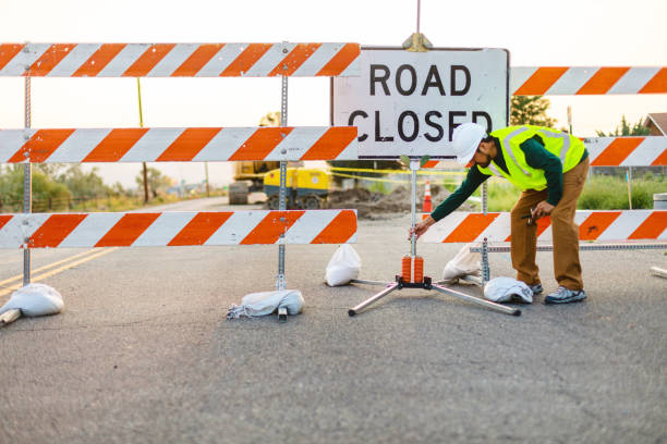 istock Hispanic Workers Setting Barriers and Directing Traffic Street Road and Highway Construction Photo Series 1345564700