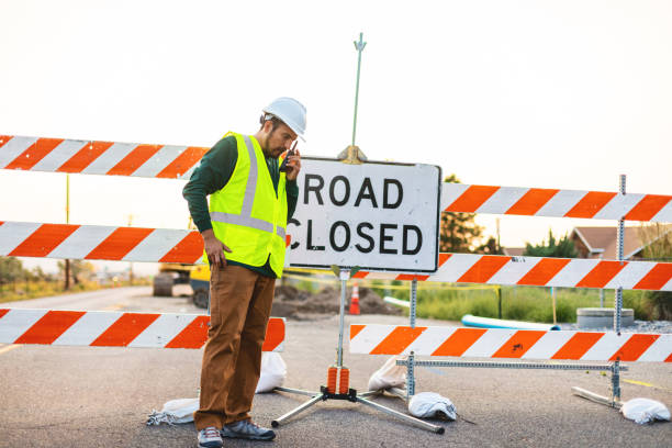 istock Hispanic Workers Setting Barriers and Directing Traffic Street Road and Highway Construction Photo Series 1345564722