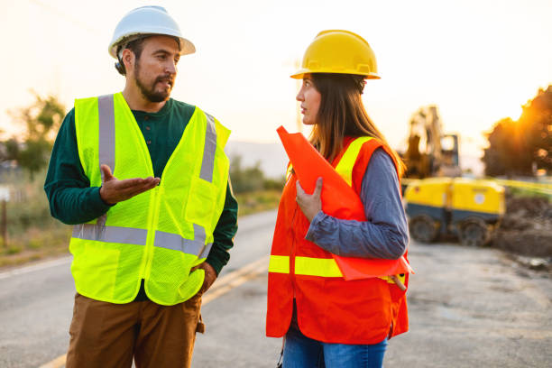 istock Hispanic Workers Setting Barriers and Directing Traffic Street Road and Highway Construction Photo Series 1345564740