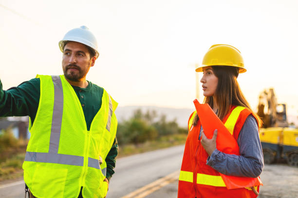 istock Hispanic Workers Setting Barriers and Directing Traffic Street Road and Highway Construction Photo Series 1345564758