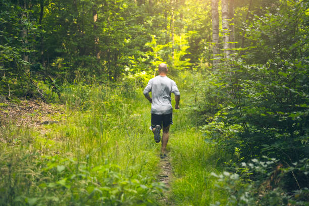 istock Trail runner with smart watch in green forest 1345564788