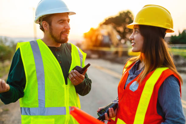 istock Hispanic Workers Setting Barriers and Directing Traffic Street Road and Highway Construction Photo Series 1345564866
