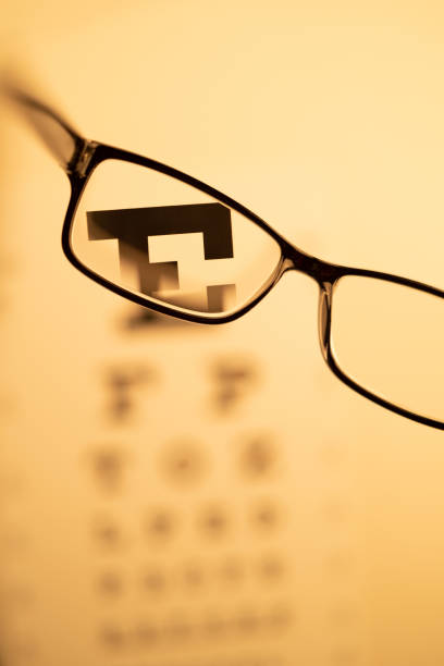 istock Eye Glasses and Out of Focus Eye Chart 1345565953