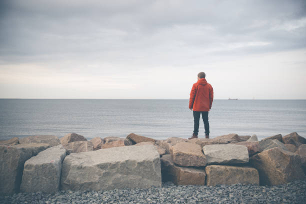 Santa Cruz de Tenerife, Spain, February 13, 2023 - Adult female angler casting her line into the sea on the Atlantic coast of Tenerife.