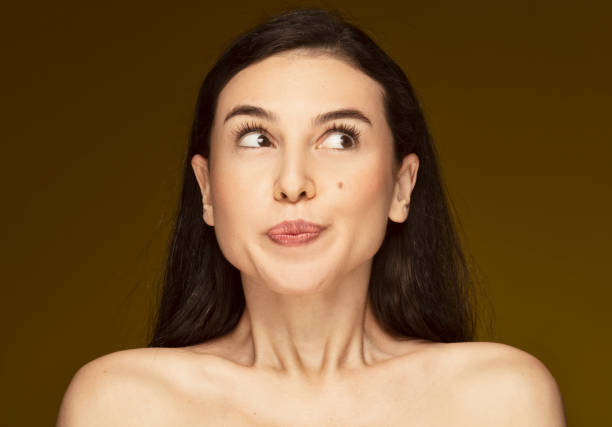 The naughty woman with a mole on her cheek watching what's going on next door with curious eyes. The naughty woman with a mole on her cheek watching what's going on next door with curious eyes. mole stock pictures, royalty-free photos & images