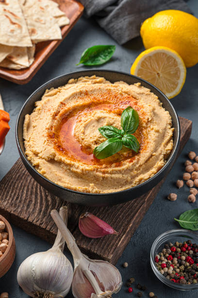 istock Hummus and ingredients on a dark background. A traditional oriental snack 1345569108