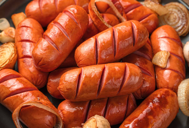 Sausages with onions and garlic close-up. Side view, horizontal