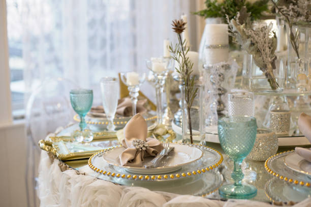 istock Nicely set table for dinner by the window. Wedding table served in white and blue colors 1345571603