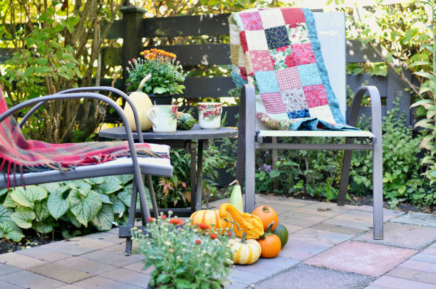 istock Backyard fall harvest decorations on sheltered patio with cozy blankets and hot drink 1345575923