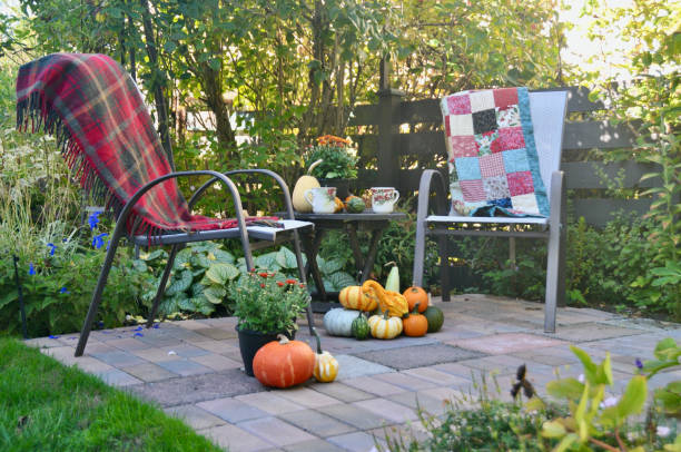 istock Backyard fall harvest decorations on sheltered patio with cozy blankets and hot drink 1345575946