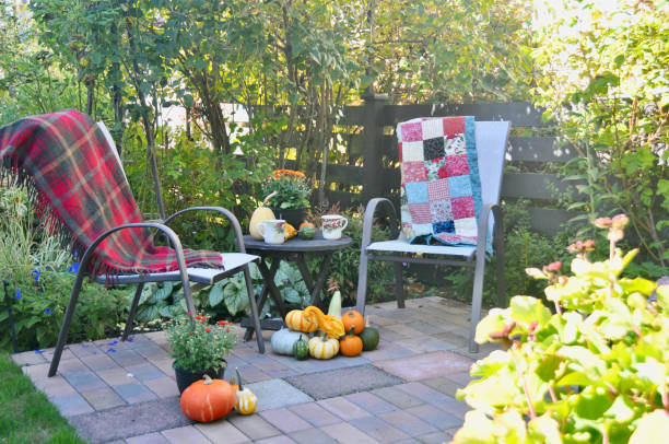 istock Backyard fall harvest decorations on sheltered patio with cozy blankets and hot drink 1345575955