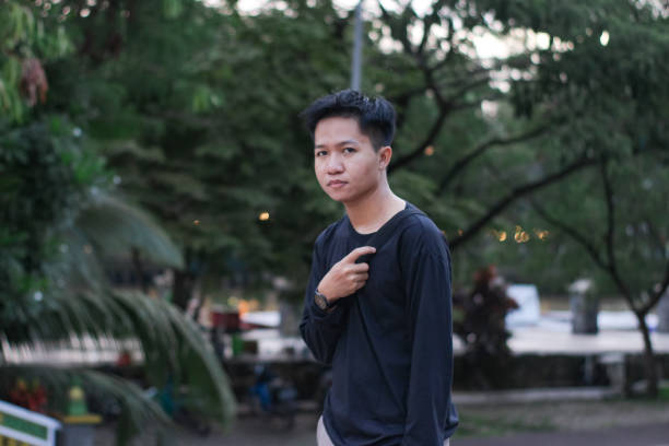 istock Young men walking at city park 1345588384