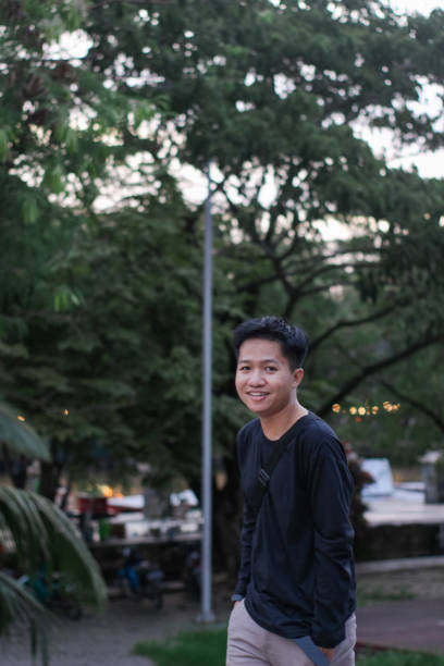 istock Young men walking at city park 1345588420