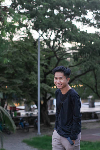 istock Young men walking at city park 1345588421