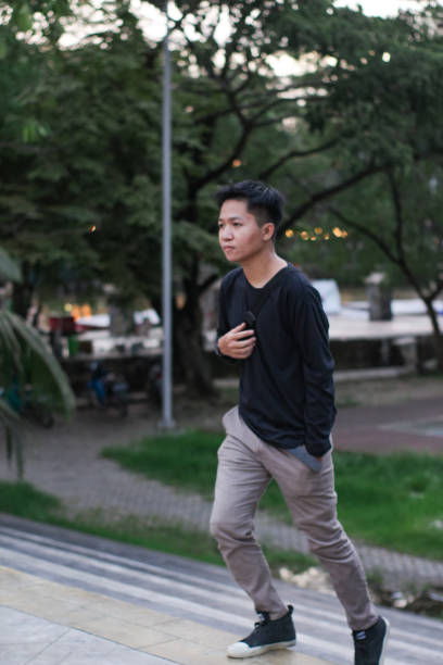 istock Young men walking at city park 1345588425