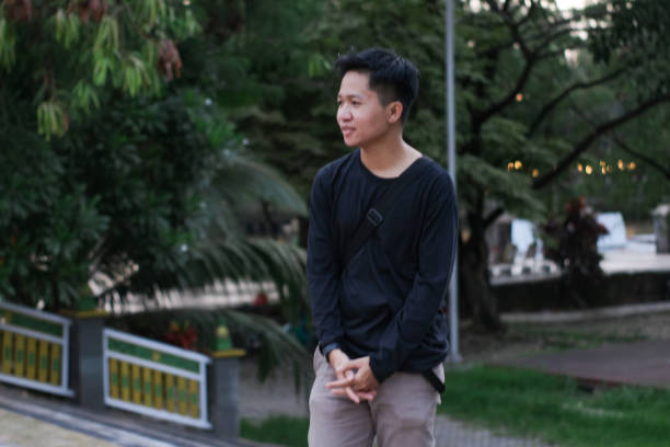 istock Young men walking at city park 1345588431