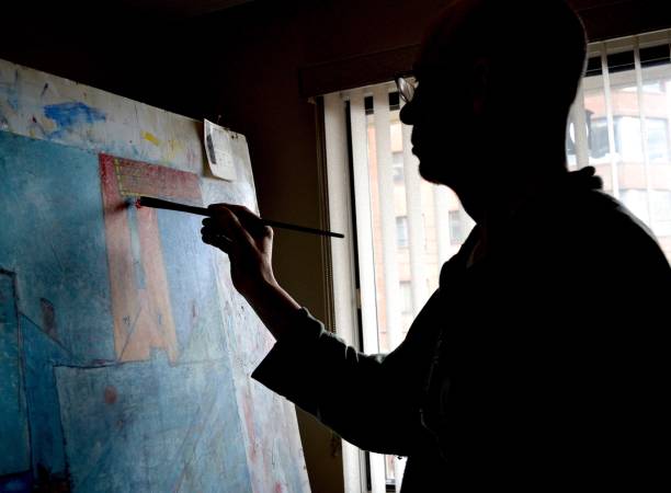 istock Artist painting in home studio 1345588639