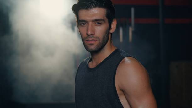 istock Personal trainer standing showing his muscles with arms crossed 1345590091
