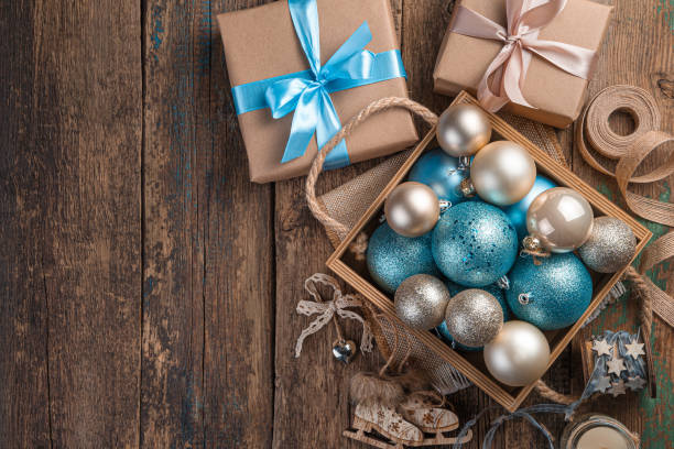 istock Christmas composition with Christmas balls and gift boxes on a wooden background 1345590170
