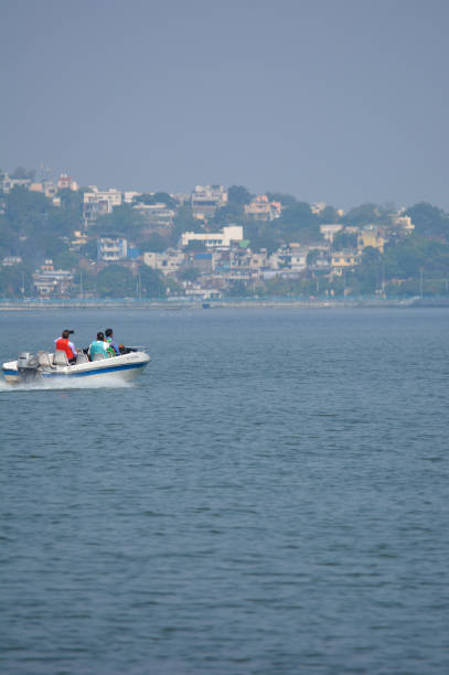 Unidentified people riding boat during summer vacation BHOPAL, MADHYA PRADESH, INDIA - NOVEMBER 20, 2019: Unidentified people riding boat during summer vacation in bhopal, Madhya Pradesh, India. Travel concept. Happy vacation. bhopal lake stock pictures, royalty-free photos & images