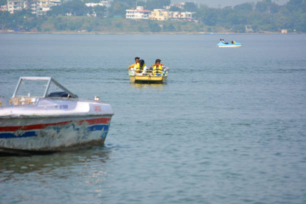 Unidentified people riding boat during summer vacation BHOPAL, MADHYA PRADESH, INDIA - NOVEMBER 20, 2019: Unidentified people riding boat during summer vacation in bhopal, Madhya Pradesh, India. Travel concept. Happy vacation. bhopal lake stock pictures, royalty-free photos & images