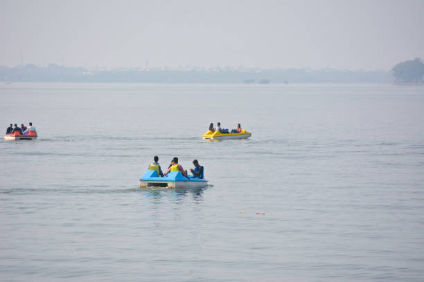Unidentified people riding boat during summer vacation BHOPAL, MADHYA PRADESH, INDIA - NOVEMBER 20, 2019: Unidentified people riding boat during summer vacation in bhopal, Madhya Pradesh, India. Travel concept. Happy vacation. bhopal lake stock pictures, royalty-free photos & images